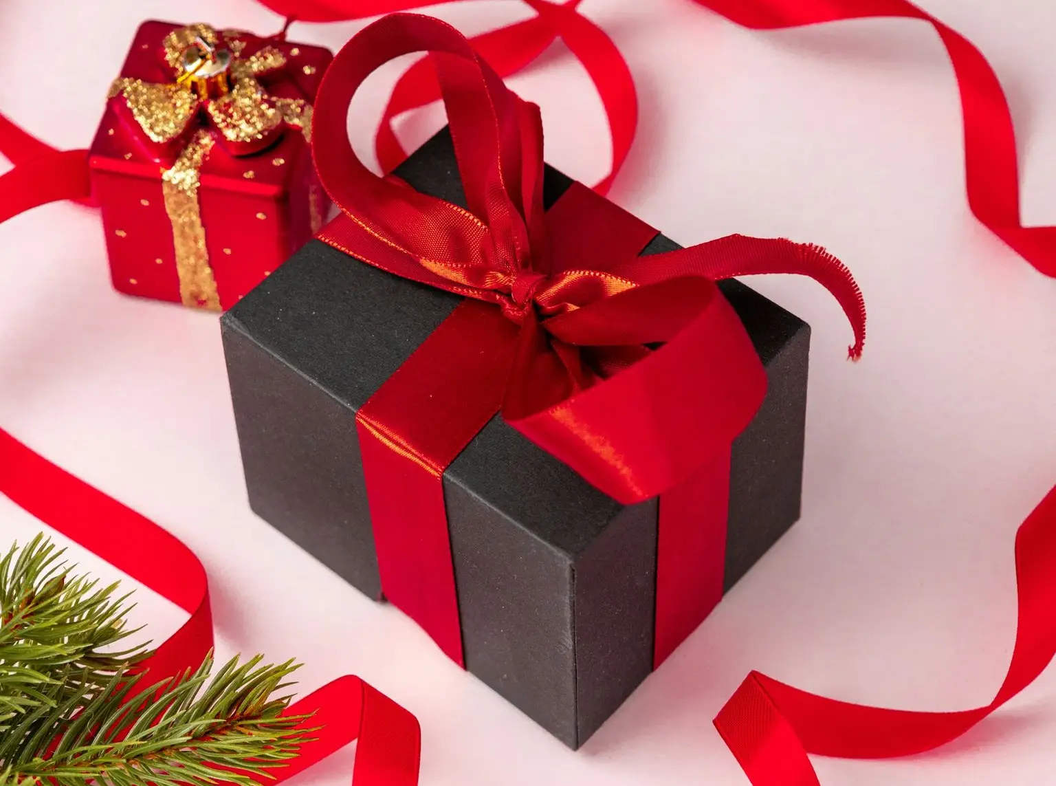 a couple of presents sitting next to a christmas tree
